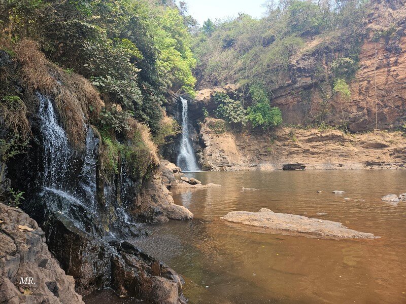Travelers exploring a natural attraction in Goa during a trip to India