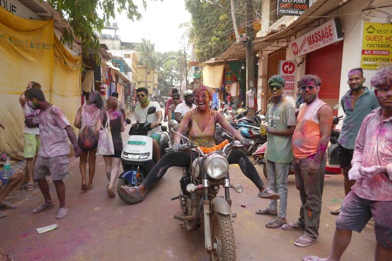 Travelers and local residents celebrating the Holi Festival together in Goa
